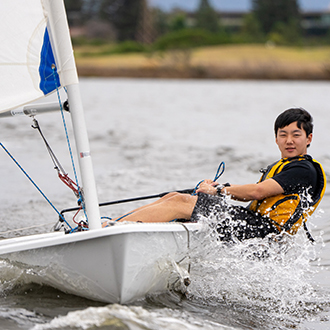 young man racing on shoreline lake young man racing on shoreline lake