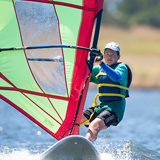 A boy windsurfing A boy windsurfing