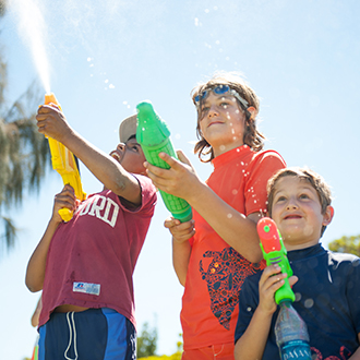 A group of boys playing with water guns. A group of boys playing with water guns.