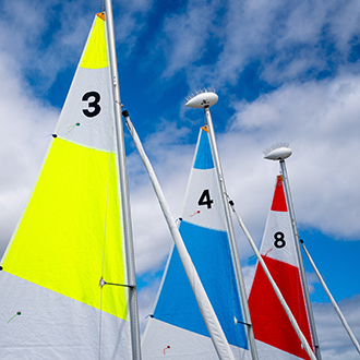 sails at dock on shoreline lake