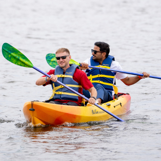 Two men in a kayak on the lake. Two men in a kayak on the lake.