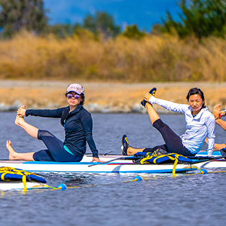 woman doing sup yoga at shoreline lake woman doing sup yoga at shoreline lake.