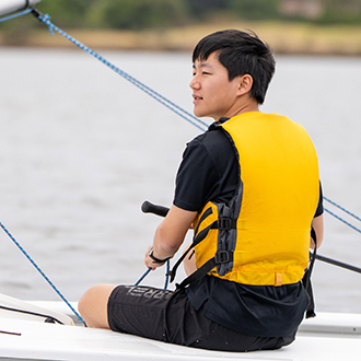 A boy in a sailboat A boy in a sailboat