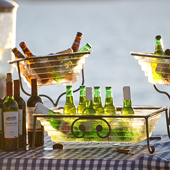 A display of cold drinks on a table at shoreline lake.